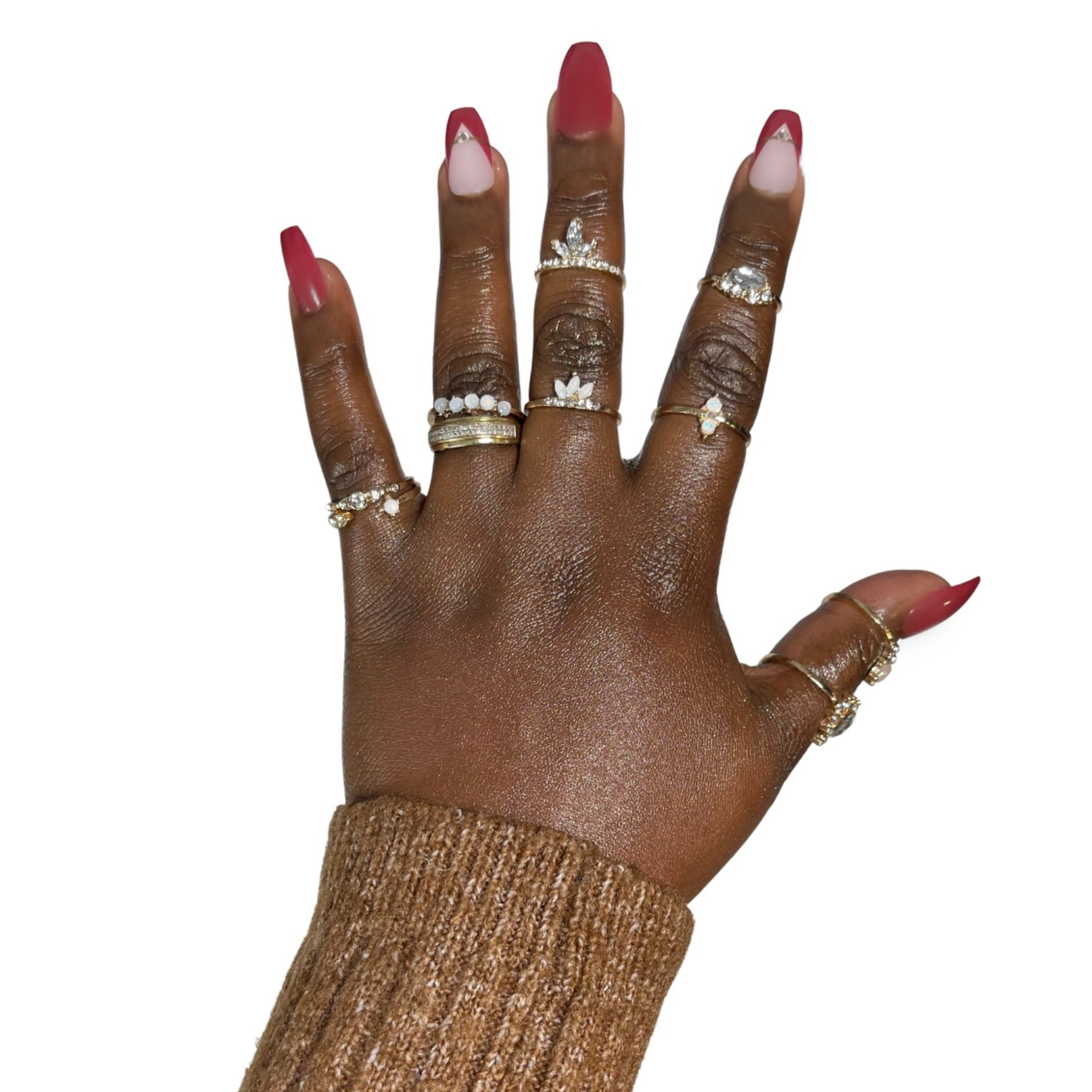 Model Wearing Casket Ready Beauty's Coffin-shaped short solid red nails with white and red V-shaped tips accent nails decorated with a gold stripe and a single rhinestone.  